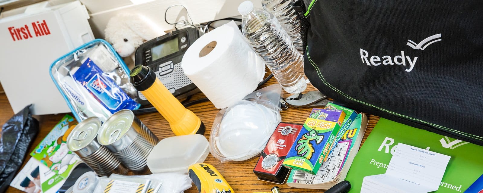 Checking expiration dates on supplies to maintain a functional survival kit.